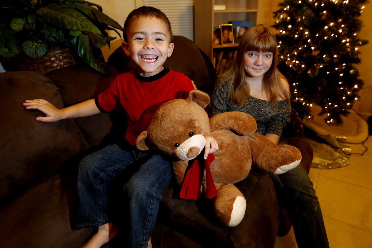 McKenna Pope, 13, right, and her brother Gavyn Boscio, 4, sit in their home in Garfield, N.J. on Dec. 6. Pope started a petition demanding Hasbro make its Easy-Bake Oven more boy friendly. (Associated Press)