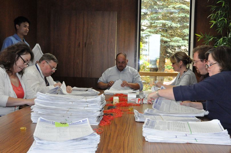 Staff for the Secretary of State's elections office begin counting petitions for I-1100 turned in June 23, 2010. (Jim Camden/Spokesman-Review)