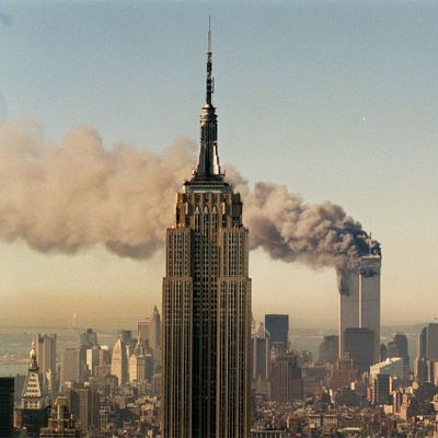 FILE - In this Sept. 11, 2001 file photo by Associated Press photographer Marty Lederhandler, the twin towers of the World Trade Center burn behind the Empire State Building in New York.  Lederhandler, an AP photographer who captured on film every U.S. president from Herbert Hoover to Bill Clinton, covered the D-Day landing in 1944 and climaxed a 66-year career with an iconic shot of the 9/ll World Trade Center attacks, died late Thursday night, March 25, 2010. He was 92. (Marty Lederhandler / Associated Press)