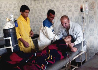 
Ali Karim, 11, is treated for shrapnel wounds in Baqouba hospital Sunday. Karim was wounded by a roadside bomb in Balad Ruz.
 (Associated Press / The Spokesman-Review)