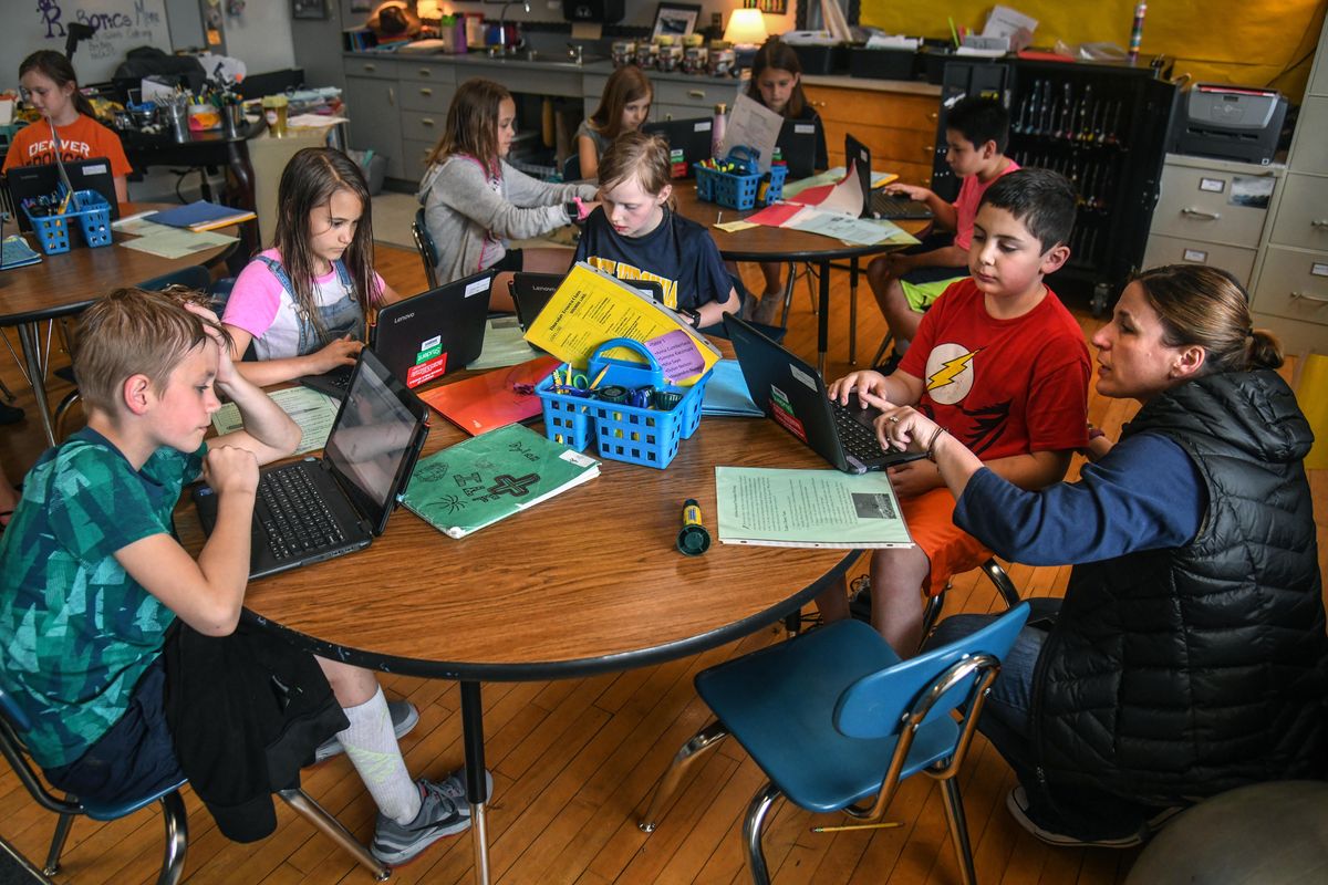 Amy Barton, Tessera instructor at Libby Center, right, works with Alejandro Nunez, Thursday, May 16, 2019, in Spokane, Wash. Other students around the table include, from left, Dylan Nelson, Mia Saye and Maddie Whitman. (Dan Pelle / The Spokesman-Review)