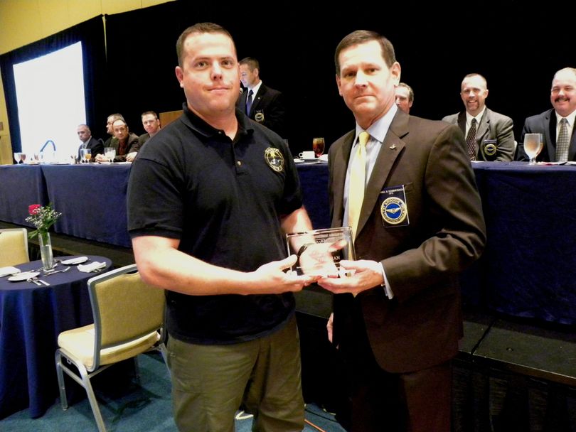 Spokane County Sheriff's deputy Jeff Thurman, left, accepts the Tactical Flight Officer of the Year award at last week's Airborne Law Enforcement Association conference in Orlando. (Courtesy of Spokane County Sheriff's Office)