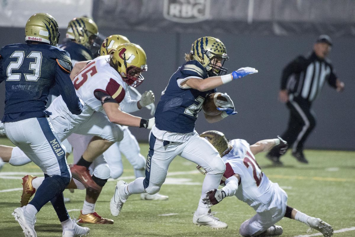 Mead running back Kannon Katzer scampers through the University High defense Tuesday at Albi Stadium. (Jesse Tinsley / The Spokesman-Review)
