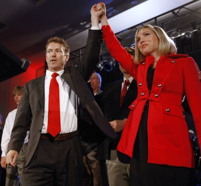 Republican U.S. Senate candidate Rand Paul raises his wife Kelley's hand as they celebrate his victory in Bowling Green, Ky., on Tuesday. (Associated Press)