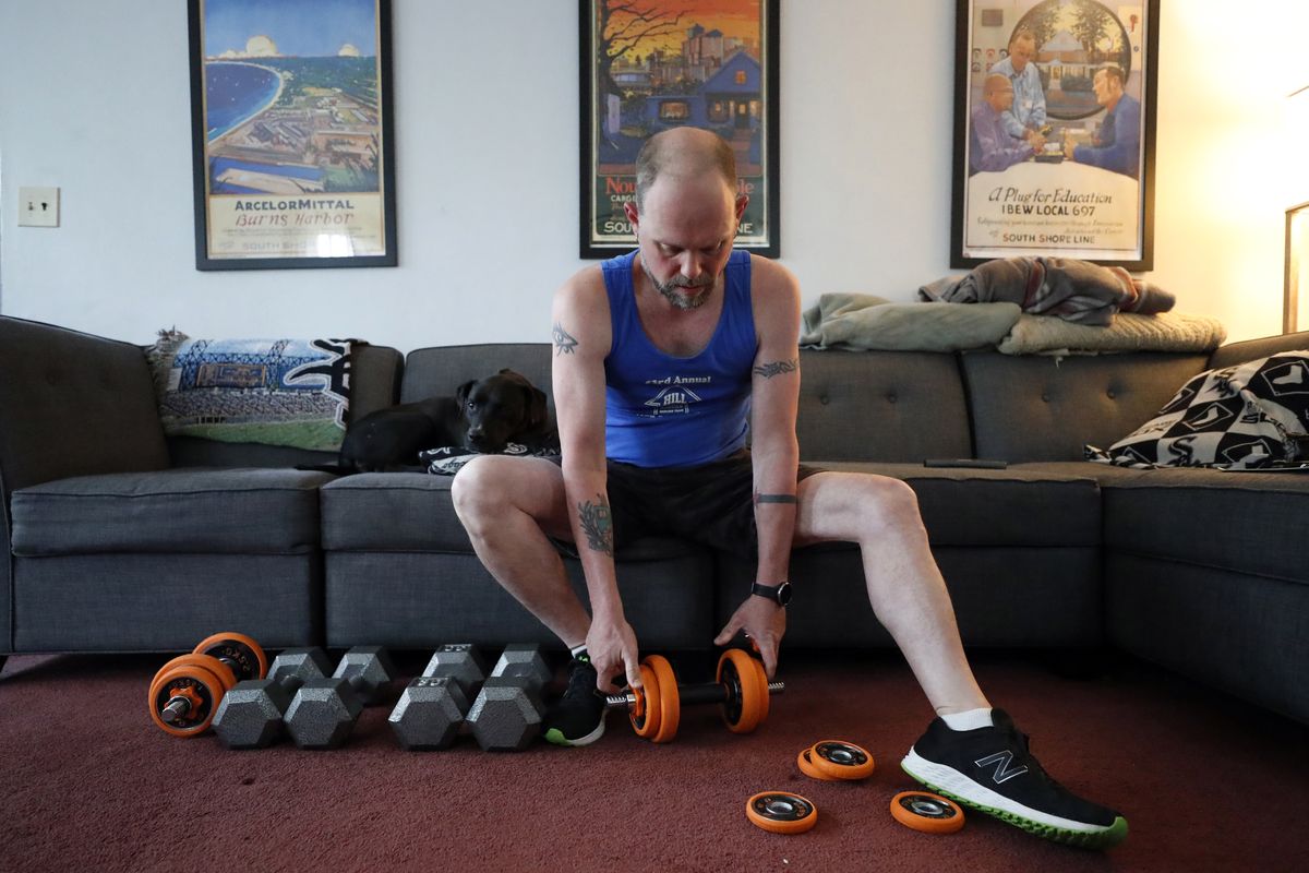 Christian Hainds prepares for a workout session at his home in Hammond, Ind., Monday, June 7, 2021. Health officials have warned since early on in the pandemic that obesity and related conditions such as diabetes were risk factors for severe COVID-19. It wasn