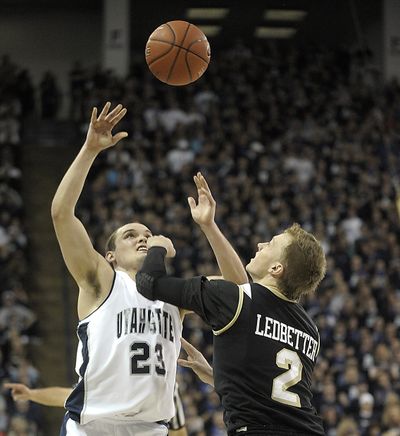 Utah State's Brian Green (23) and Idaho's Jeff Ledbetter fight for a loose ball during the second half. (Associated Press)