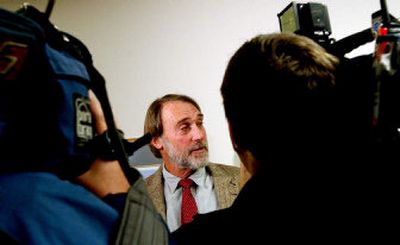 
 Barry Rosenberg  of Kootenai Environmental Alliance delivered petitions containing more than 7,600 signatures to Gus Johnson, chairman of the Kootenai commission. 
 (Kathy Plonka / The Spokesman-Review)