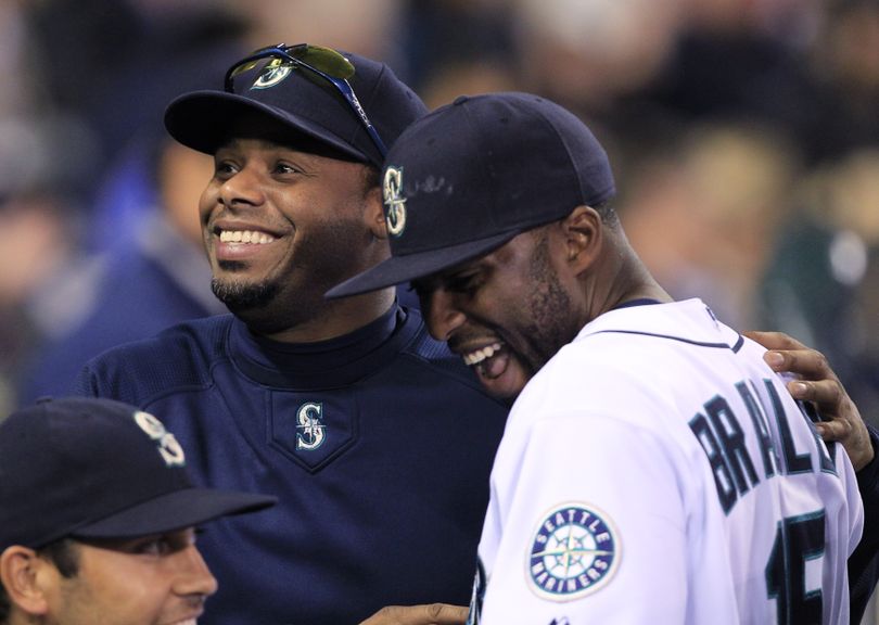 Seattle Mariners' Ken Griffey Jr., left, and Milton Bradley share a laugh in the dugout as the team takes a lead against the Minnesota Twins in the fourth inning during a baseball game Tuesday, June 1, 2010, in Seattle. (Elaine Thompson / Associated Press)