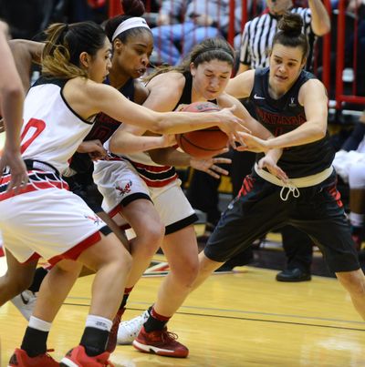 From left, Eastern Washington University’s Tisha Phillips, Gonzaga’s Zhane Templeton, EWU’s Delaney Hodgins and GU’s Makenlee Williams battle for the loose ball on Dec. 11, 2016, at Reese Court in Cheney. Trustee Christa Hazel of the Coeur d’Alene School District recently encountered a “Caveman” who believes women don’t belong on a basketball court. (Jesse Tinsley / The Spokesman-Review)