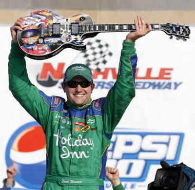 
Associated Press Scott Wimmer holds up the winner's trophy in victory circle after winning the Pepsi 300 Saturday.
 (Associated Press / The Spokesman-Review)