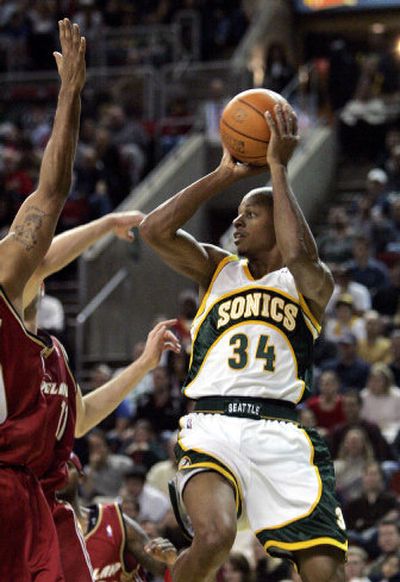 
SuperSonics' Ray Allen leaps and passes against the Cavaliers. He finished with 21 points.
 (Associated Press / The Spokesman-Review)