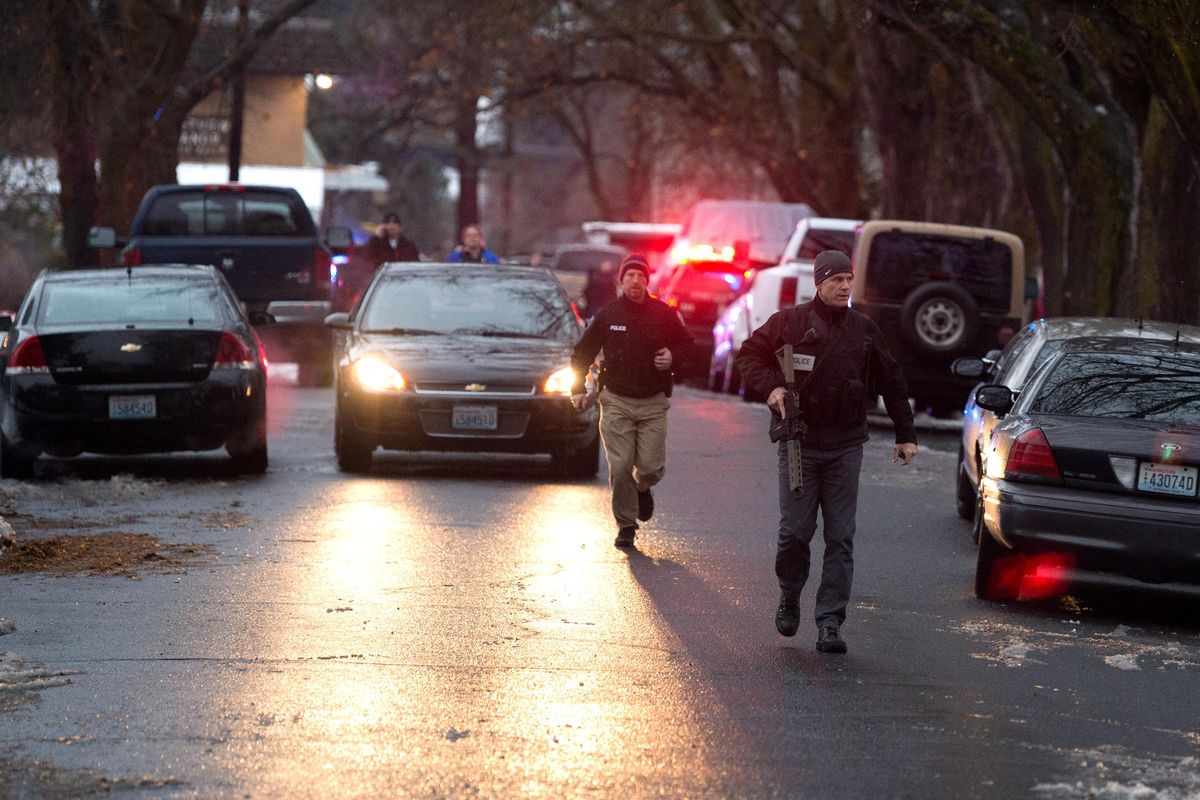Officers move to block off South Elm and West 10th during after they responded to an active shooter on Tuesday, December 19, 2017, near in Spokane. (Tyler Tjomsland / The Spokesman-Review)