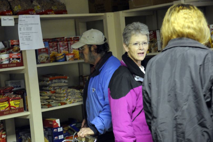 North Palouse Community Food Bank president Sheila Dyer assists a client last Thursday. Although the food bank is open only limited hours, Dyer will let people set up appointments for emergency needs. The food bank serves Fairfield, Rockford, Latah and Waverly. (J. Bart Rayniak)