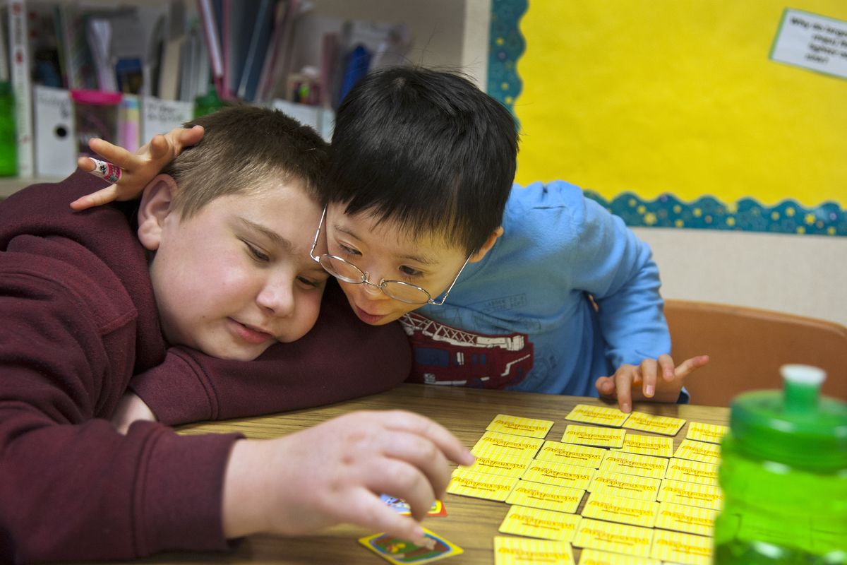Madison Elementary School students Corbin Fritz, left, and Chris Nathaniel play a memory game during a meeting of the Madison Buddies last Wednesday. The Madison Buddies program partners general education and special education students at lunch and in the classroom to help develop relationships. (Dan Pelle)