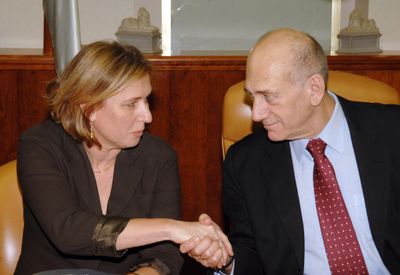 Associated Press  Prime Minister Ehud Olmert shakes hands with Foreign Minister Tzipi Livni Sunday during a cabinet meeting in Jerusalem. (Associated Press / The Spokesman-Review)