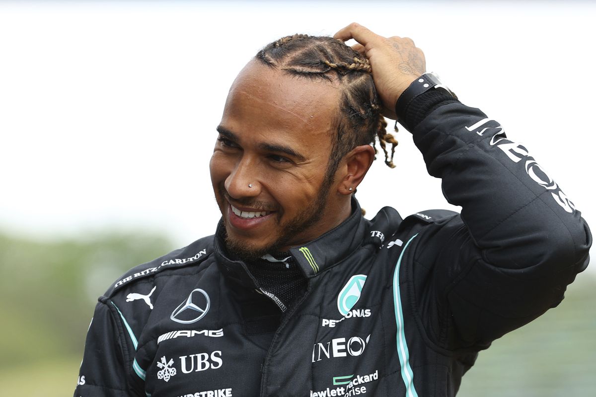 Mercedes driver Lewis Hamilton of Britain smiles after taking the fastest time during qualifying practice for Sunday