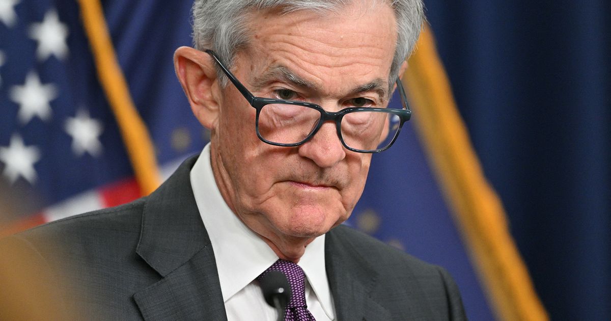 Fed holds rates, sees slower growth and higher inflation