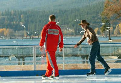 
Charles Page, right, chats with skate guard Desmond Boston on Saturday at the South Pole Skating Village, a new outdoor ice rink at the Coeur d'Alene Resort. The rink will be open through Jan. 6. 
 (Jesse Tinsley / The Spokesman-Review)