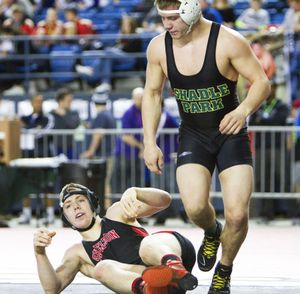 Shadle Park's Kyle Vinson, right, leaves Shelton's Colton Paller on the mat during their opening round 182 lb. match in the 3A State Wrestling Tournament in Tacoma, Wash., Friday, Feb. 20. 2015. Vinson won the match by pin to advance. (Patrick Hagerty / Patrick Hagerty)