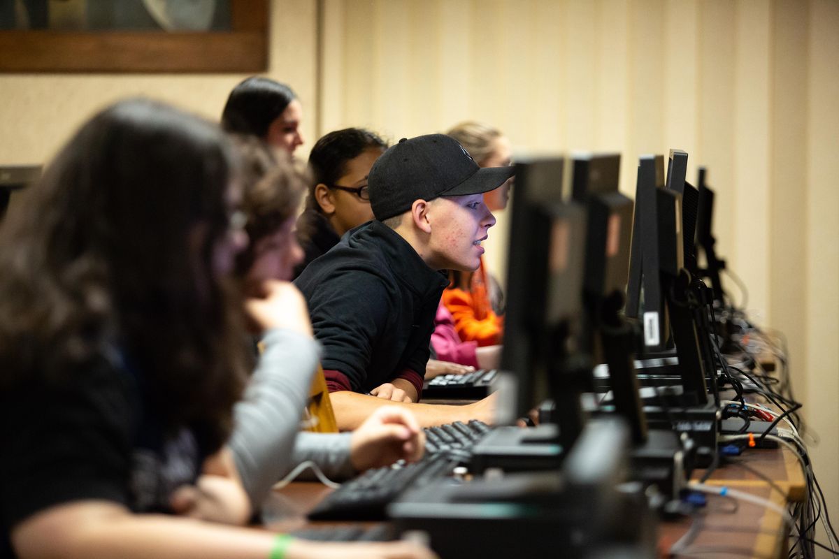 Freshman Aiden Butler looks at a computer among peers during a zero hour speech and debate class in the Lewis and Clark High School library on Oct. 5, 2018. The class started at 7 a.m. (Libby Kamrowski / The Spokesman-Review)