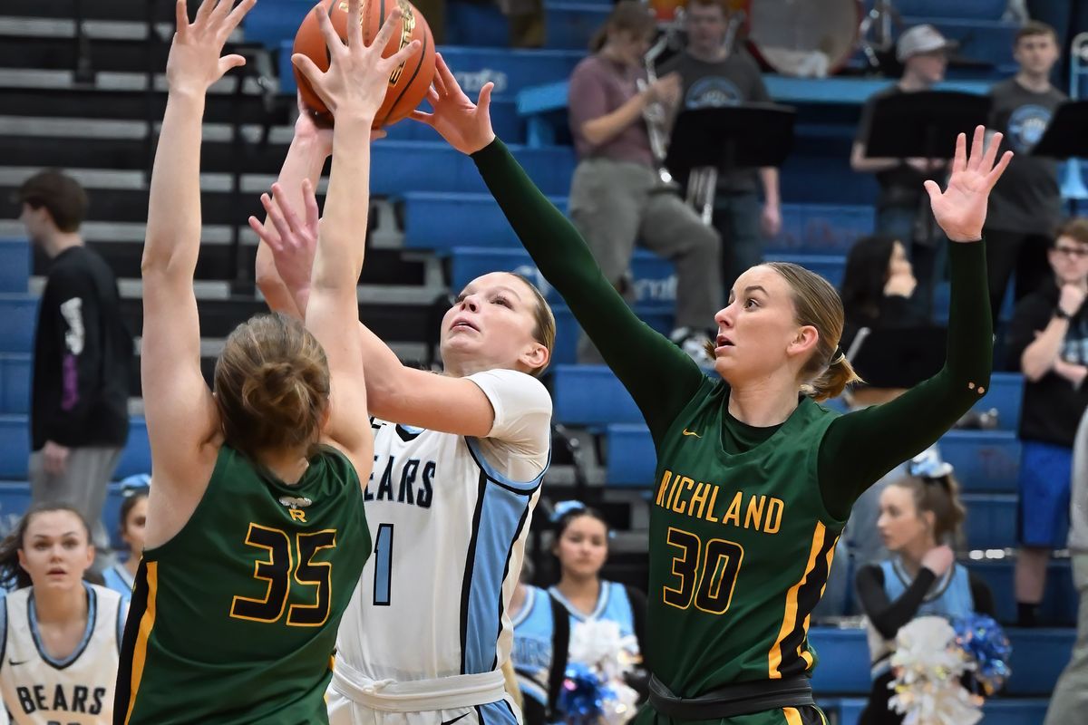 Central Valley’s Autumn Agnew shoots over a pair of Richland defenders during Tuesday’s District 8 4A semifinal girls basketball game at Central Valley.  (Colin Mulvany/The Spokesman-Review)