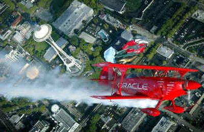 
The Oracle Challenger stunt plane makes a pass over the Seattle Space Needle during an aerial tour Thursday in preparation for the air show at Seafair.
 (Associated Press / The Spokesman-Review)