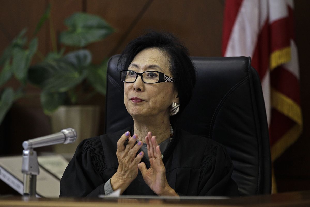 Judge Lillian Sing applauds a defendant on the bench of the Community Court Tuesday, Sept. 18, 2012, in San Francisco. While it�s been difficult for researchers to determine cost savings by the courts, new studies suggest the courts are helping stem crime. An evaluation of Washington, D.C.�s community court by the Westat research firm found this summer that defendants who successfully completed diversion programs from 2007 to 2009 were half as likely to reoffend as similar defendants in a traditional court. (Ben Margot / Associated Press)