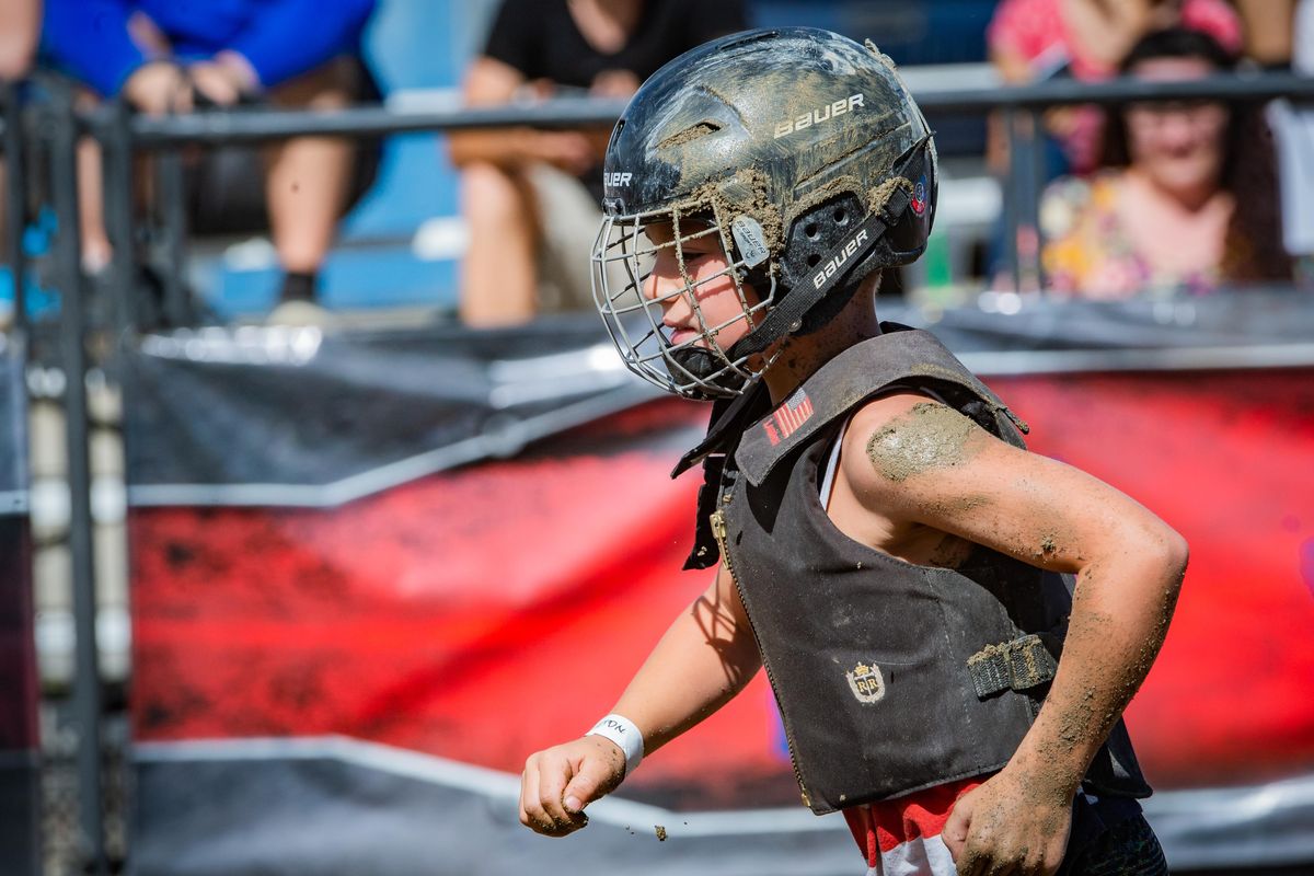 Ashton, a young contestant, shakes the dirt off and heads to the exit after mutton bustin