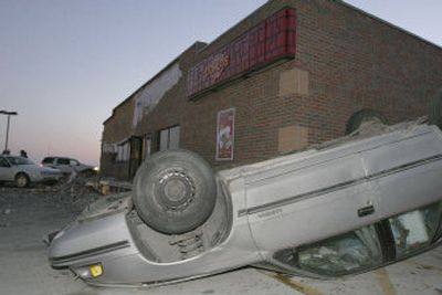 
An overturned car sits in the parking lot of Casey's General Stores in Woodward, Iowa, after a tornado struck Saturday. 
 (Associated Press / The Spokesman-Review)