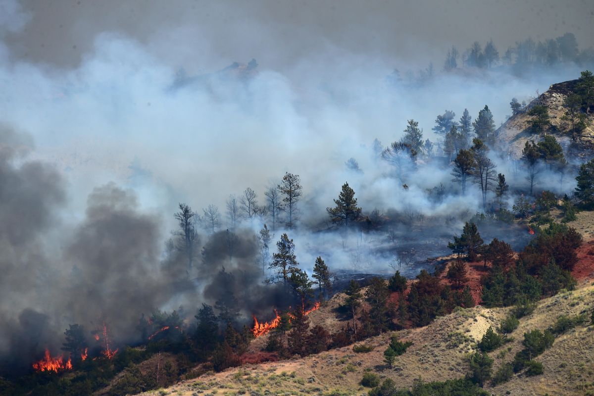 In this Sunday, July 23, 2017, photo, a wildfire burns near Sand Springs in northeast Montana. The Lolo Peak Fire in western Montana blew up overnight leading law enforcement officers to order the evacuation of up to 400 more homes west of the town of Lolo. (Rebecca Noble / Rebecca Noble/Billings Gazette)