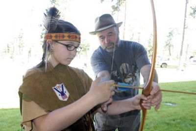 
Archer and bow builder Keith Anyan, right, instructs Baeley Hathaway 10, how to use a long bow at Ponderosa Elementary. 
 (JESSE TINSLEY Photo / The Spokesman-Review)