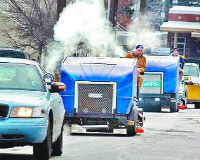
Police escort two ice resurfacing machines on Howard Street Tuesday. The machines will be used to surface a U.S. Figure Skating Championships  rink at the Group Health Exhibit Hall. 
 (Christopher Anderson / The Spokesman-Review)