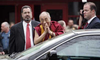
The Dalai Lama motions to a crowd  after participating in a panel discussion about philanthropy Sunday in Seattle. Associated Press
 (Associated Press / The Spokesman-Review)
