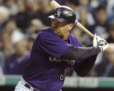 In this June 30, 2004 photo, Colorado Rockies’ Larry Walker gets ready to swing at a pitch from Milwaukee Brewers’ Ben Sheets in the fourth inning of a baseball game in Denver. Derek Jeter came within one vote of being a unanimous pick for the Hall of Fame while Larry Walker also earned baseball’s highest honor on Tuesday, Jan. 21, 2020. (David Zalubowski / Associated Press)