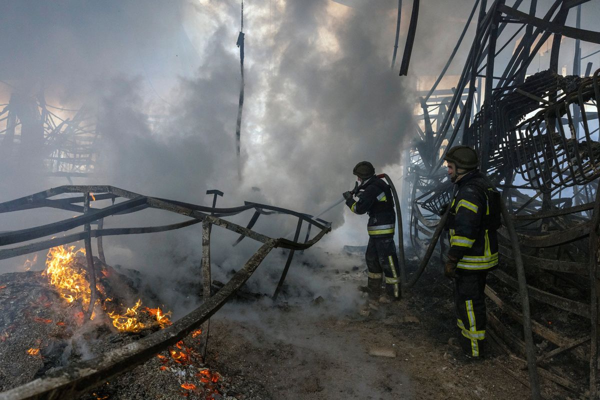 Firefighters work to put out a blaze caused by a Russian strike on a shopping mall on Friday morning in Kherson, Ukraine.  (IVOR PRICKETT)