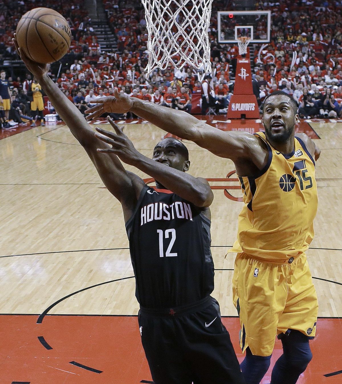 Houston Rockets forward Luc Mbah a Moute (12) drives to the basket as Utah Jazz forward Derrick Favors defends during the second half in Game 1 of an NBA basketball second-round playoff series, Sunday, April 29, 2018, in Houston. Houston won 110-96. (Eric Christian Smith / Associated Press)