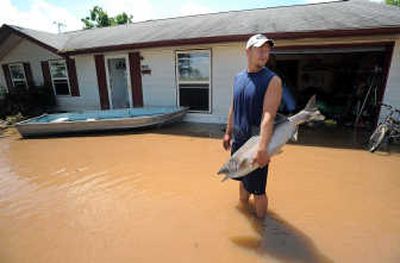 
David Shepard removes a stuffed king salmon from his flooded home Sunday in Edinburgh, Ind. Associated Press
 (Associated Press / The Spokesman-Review)