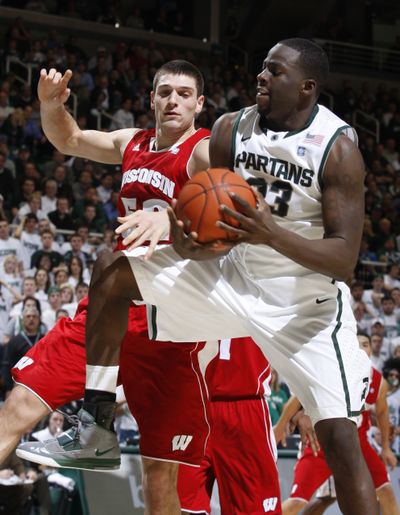 Michigan State's Draymond Green, right, and Wisconsin's Keaton Nankivil fight for a rebound on Tuesday night.  (Associated Press)