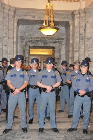 State troopers form a line outside the governor's office after 13 demonstrators were arrested while trying to rush the doors. (Jim Camden/The Spokesman-Review)