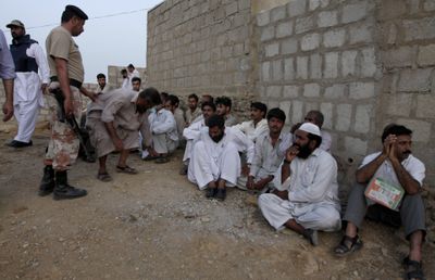 In this April 29  photo, paramilitary soldiers round up members of the ethnic Pashtun community during a clash with local people in Karachi, Pakistan.  (Associated Press / The Spokesman-Review)