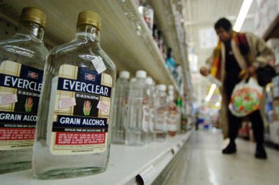 
A customer shops near the remaining bottles of grain alcohol Wednesday at Liquor Mart in Charleston, W.Va. 
 (Associated Press / The Spokesman-Review)