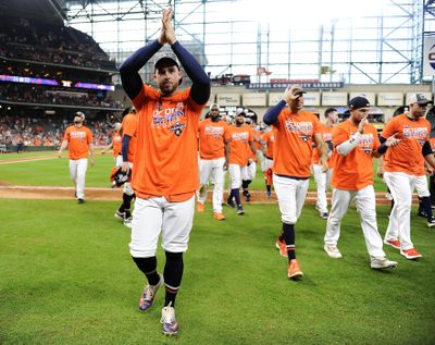 Houston Astros' George Springer, left, celebrates the team's clinching of the AL West crown after a baseball game against the Los Angeles Angels, Sunday, Sept. 22, 2019, in Houston. (Eric Christian Smith / Associated Press)