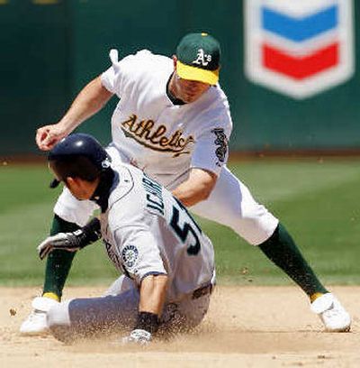 
Seattle Mariners' Ichiro Suzuki is tagged out by Oakland Athletics' Bobby Crosby in the fifth inning while trying to steal second.  
 (Associated Press / The Spokesman-Review)