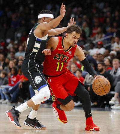 In this March 31, 2019 photo, Atlanta Hawks guard Trae Young (11) drives to the basket as Milwaukee Bucks guard Tim Frazier (12) defends in overtime of an NBA basketball game, in Atlanta. With a pair of picks in the top 10 – or perhaps a single selection that’s higher than what they have now, should they work out a trade – the Hawks can add to a pair of gems from the last two drafts, Trae Young and John Collins. (Todd Kirkland / Associated Press)
