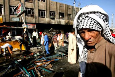 
A man checks damage done by a car bomb in the mainly Shiite neighborhood of Shaab in Baghdad  on Tuesday. The car bomb detonated Monday evening,  killing 13 people and wounding 46. 
 (Associated Press / The Spokesman-Review)