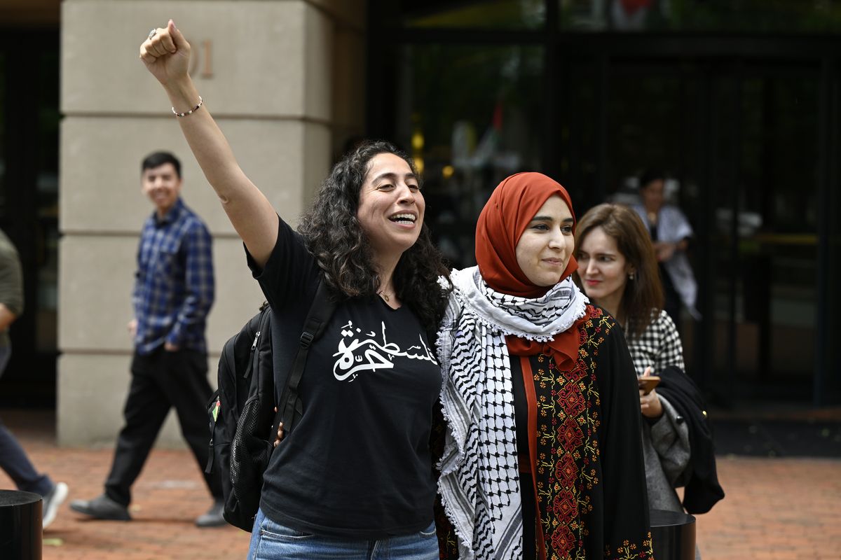 Samar Saeed, left, stands with Mapheze Saleh, the wife of Badar Khan Suri, after a judge ordered Suri’s release on Wednesday in Alexandria, Va. (Matt McClain/The Washington Post)
