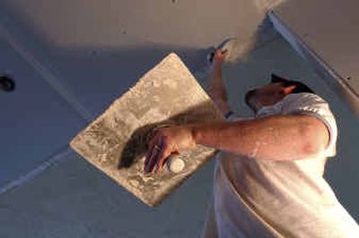 
Shawn Sanders of Edgecraft Finishing Repairs works on Sheetrocking the kitchen ceiling in a South Hill home purchased by Dan Brown and Shaani Robideaux in the spring of 2004.
 (Kathryn Stevens / The Spokesman-Review)