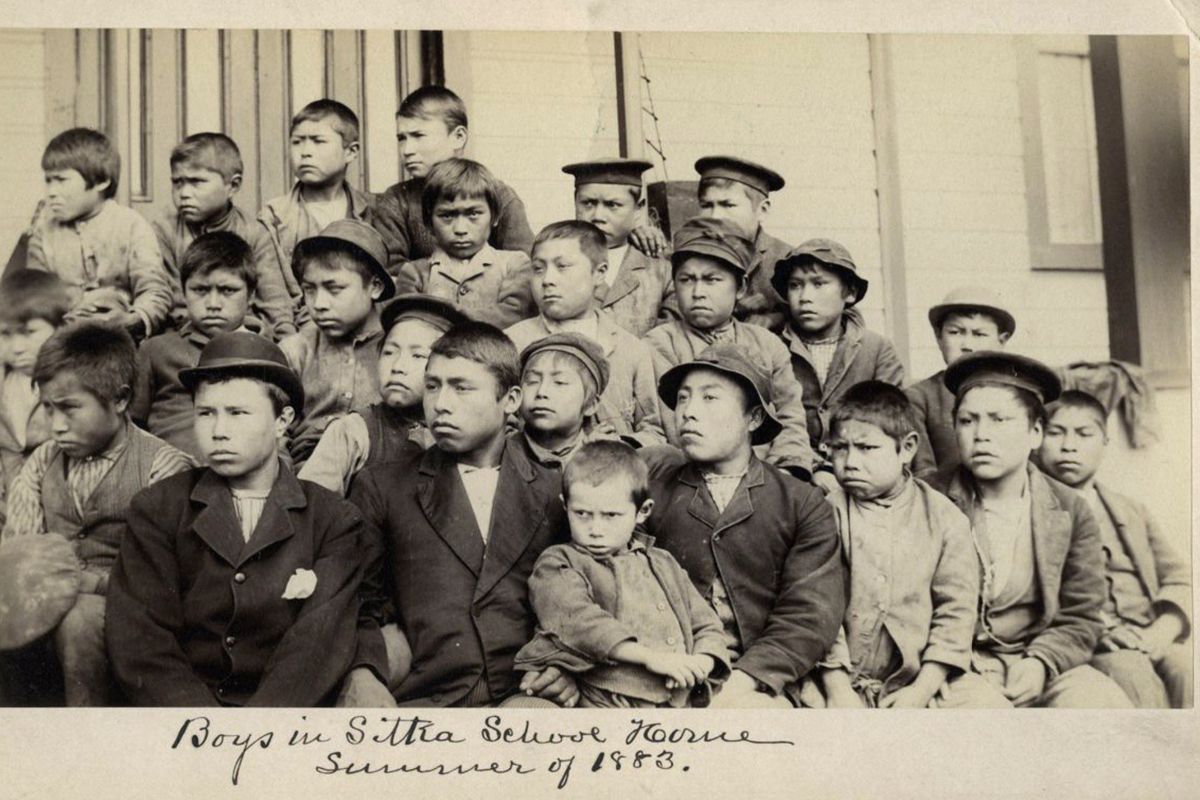 FILE - This photo made available by the Presbyterian Historical Society, Philadelphia shows students at a Presbyterian boarding school in Sitka, Alaska in the summer of 1883. U.S. Catholic and Protestant denominations operated more than 150 boarding schools between the 19th and 20th centuries. Native American and Alaskan Native children were regularly severed from their tribal families, customs, language and religion and brought to the schools in a push to assimilate and Christianize them.  (HONS)