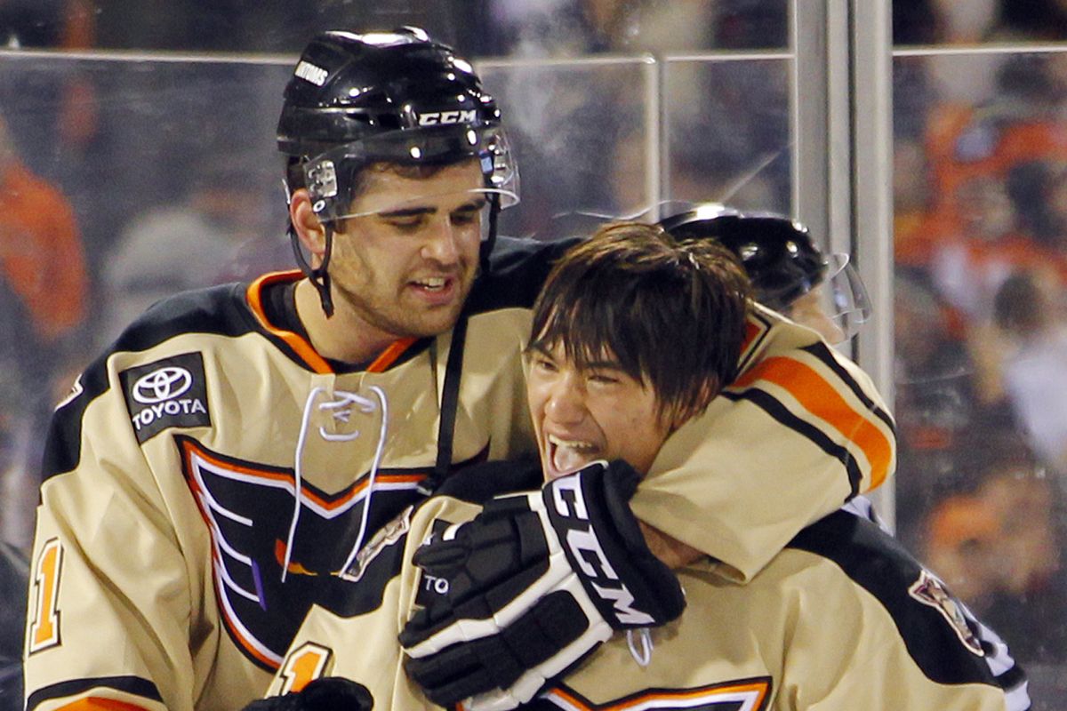 Adirondack teammates Tom Sestito, rear, and Shane Harper celebrate after winning a game played under the AHL’s new OT rules. (Associated Press)