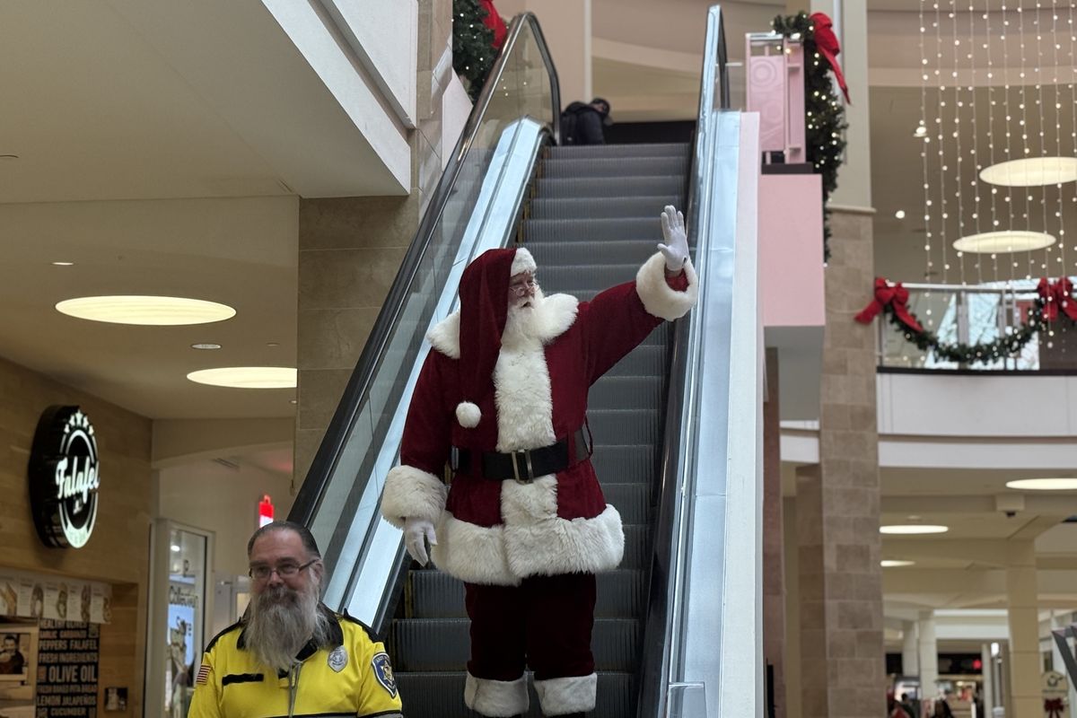 Michael Graham descends the escalator as Santa on Saturday at the Tysons Corner Center mall in Virginia. (Liam Scott/The Washington Post)